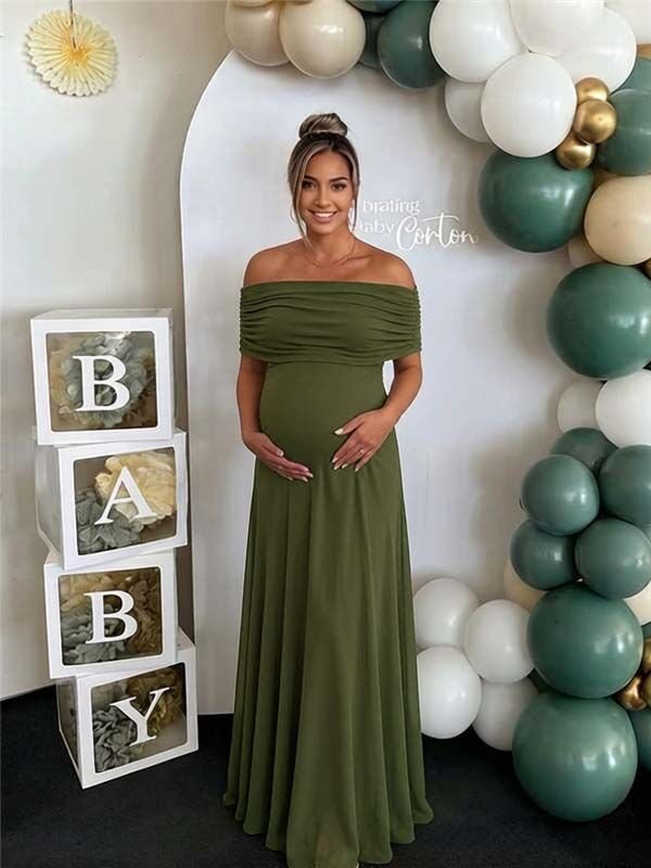 Green maternity maxi dress with off-shoulder mesh draped design and elegant cocktail silhouette.