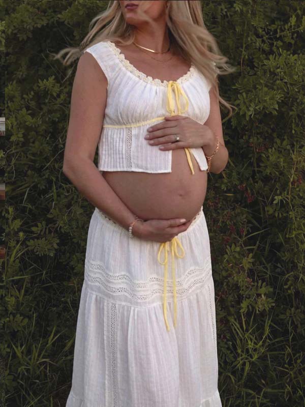 White Boho lace maternity maxi dress with ribbon high-waisted two-piece design and fitted silhouette.