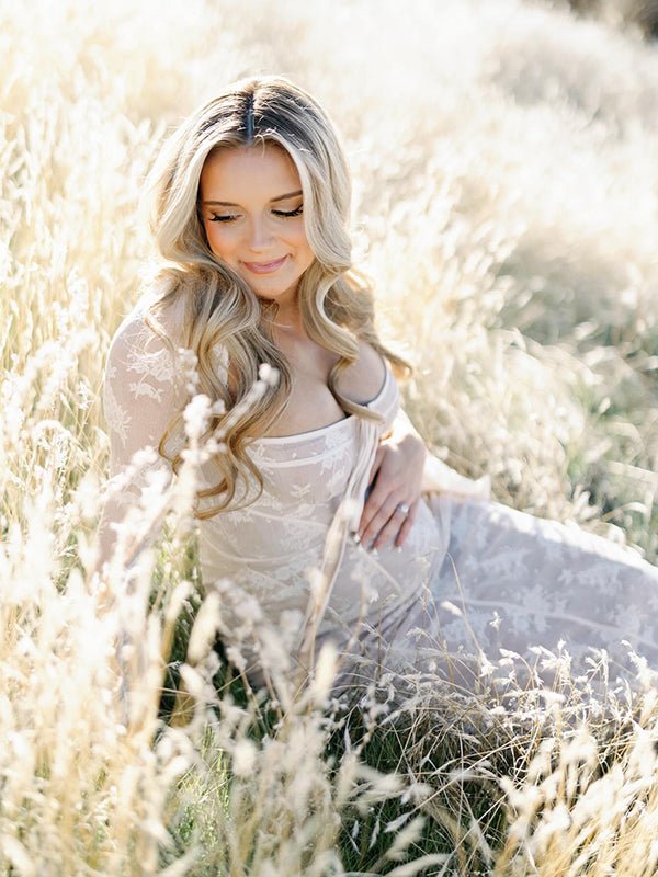 White lace maternity maxi dress with corset bodice and bodycon silhouette.