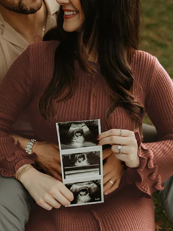 Brown knit maternity maxi dress with flare sleeves and ruffle details.