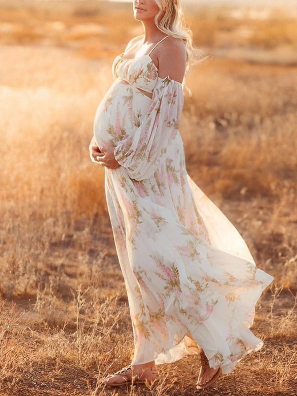 White floral maternity maxi dress with off-shoulder cut out design and flowy silhouette.